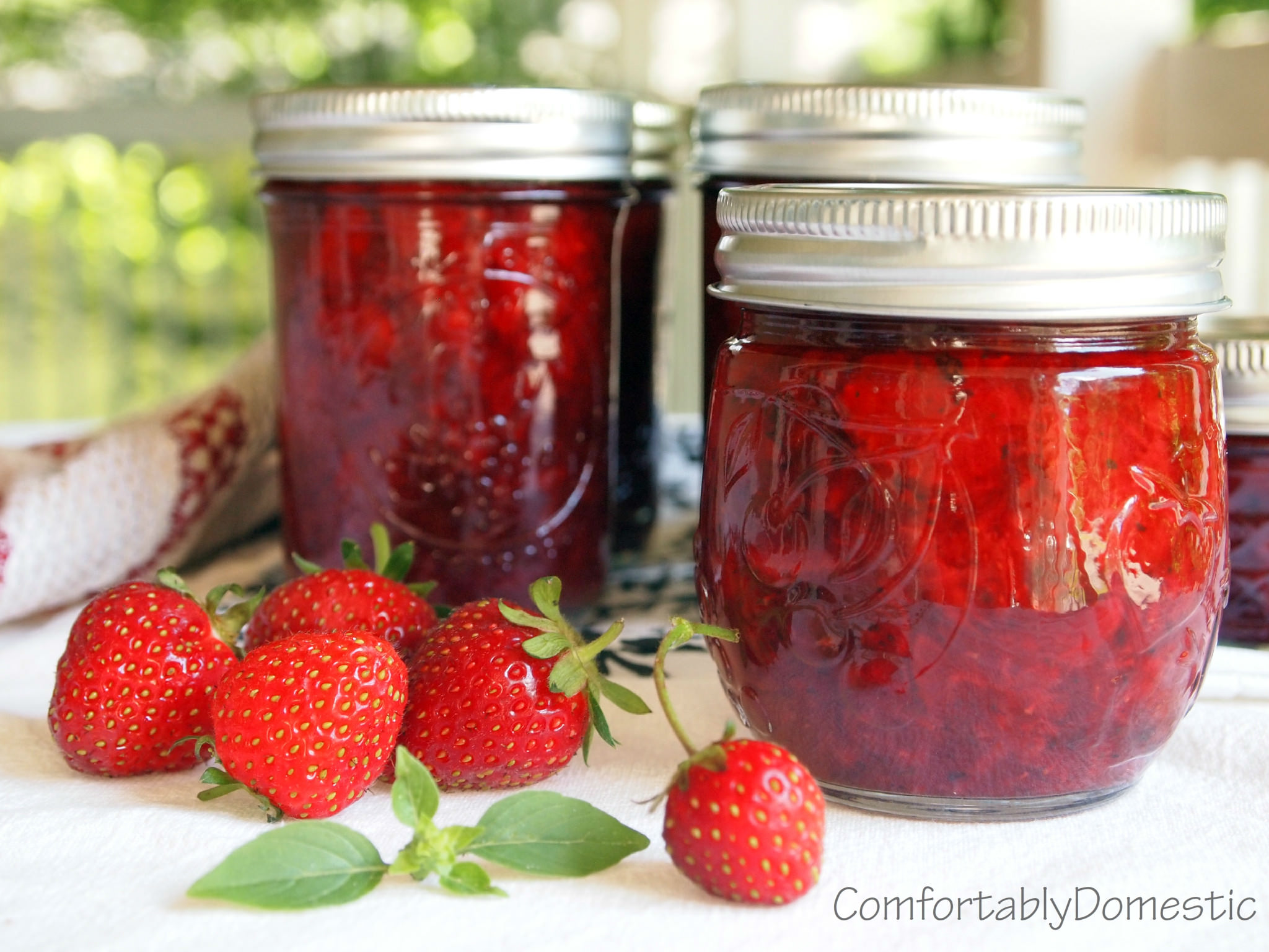 No sugar added strawberry-basil jam transforms summer's freshest strawberries and fresh basil into a delicious, naturally sweetened condiment. | ComfortablyDomestic.com